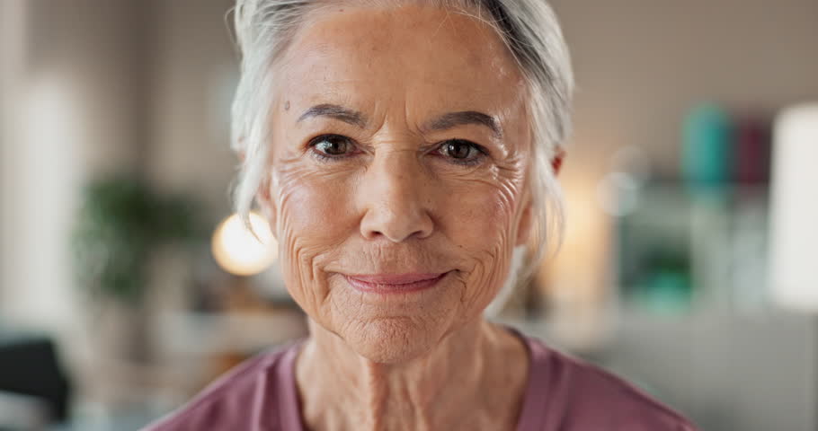 Happy, sofa and face of senior woman in home for relaxing, resting and enjoy weekend. Smile, retirement and portrait of elderly person with laugh for funny joke, humor and carefree in living room