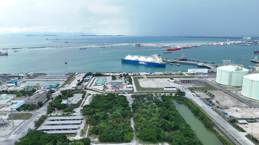 LNG (Liquified Natural Gas) tanker anchored in Gas terminal gas tanks for storage. Oil Crude Gas Tanker Ship. LPG at Tanker Bay Petroleum Chemical or Methane freighter export import transportation