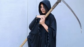 Teenage girl dressed for Halloween party in costume of Holy Death on grey background, horizontal 4k footage - Powered by Shutterstock - Get 15% off with code: PIKWIZARD15