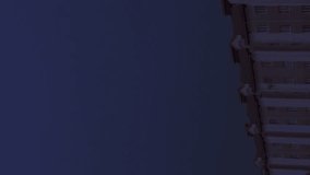 A breathtaking display unfolds as lightning streaks across the night sky, illuminating the exterior of a multi-story building. Nature's power captivates as storms brew overhead. Vertical video - Powered by Shutterstock - Get 15% off with code: PIKWIZARD15