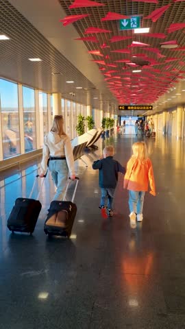 family rushing to flight gate in airport