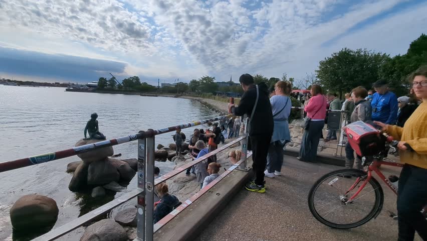 Copenhagen, Denmark - Sep 16, 2024: people take pictures near the statue of the little mermaid