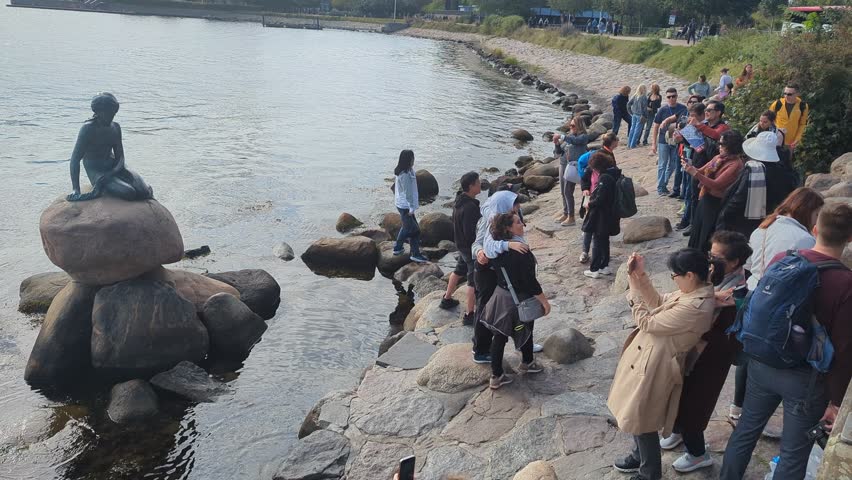 Copenhagen, Denmark - Sep 16, 2024: people take pictures near the statue of the little mermaid