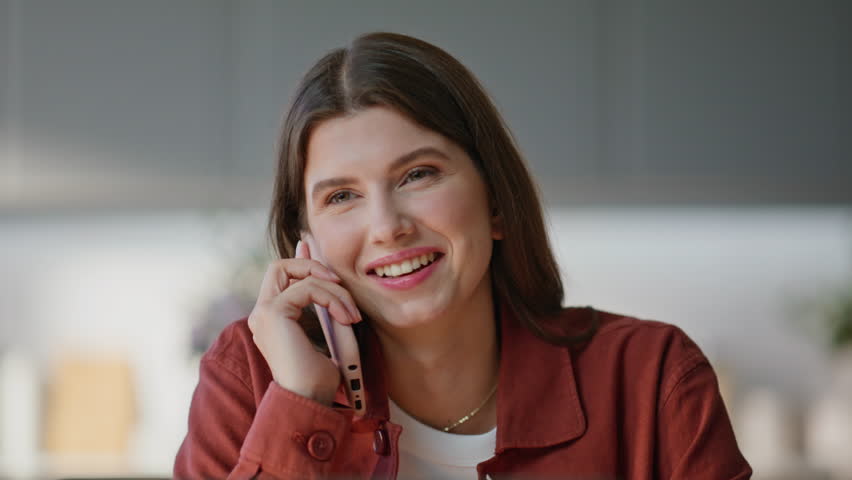 Brunette woman calling mobile phone in home office closeup. Emotional freelancer speaking smartphone having pleasant conversation at desk. Smiling manager discussing news working at computer buro - Powered by Shutterstock - Get 15% off with code: PIKWIZARD15