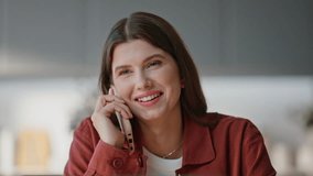 Brunette woman calling mobile phone in home office closeup. Emotional freelancer speaking smartphone having pleasant conversation at desk. Smiling manager discussing news working at computer buro - Powered by Shutterstock - Get 15% off with code: PIKWIZARD15