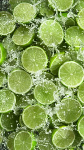 Super Slow Motion of Falling Limes Slices into Water . Filmed on High Speed Cinema Camera , 1000fps