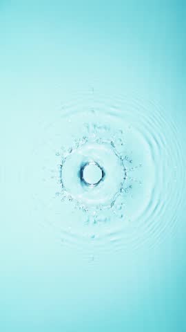 Slow motion of splashing water drops on on light blue background , filmed on high speed cinematic camera at 1000 FPS