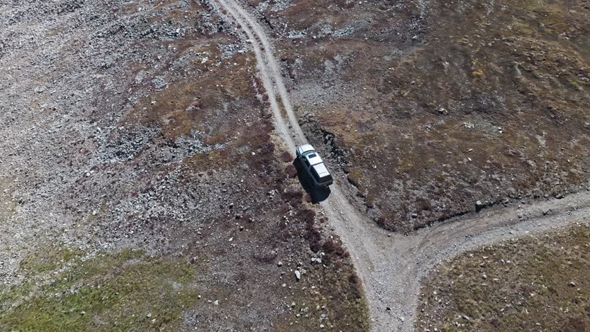 Drone top down overview of truck driving on treacherous dirt road of the Peak 10 trail Breckenridge Colorado