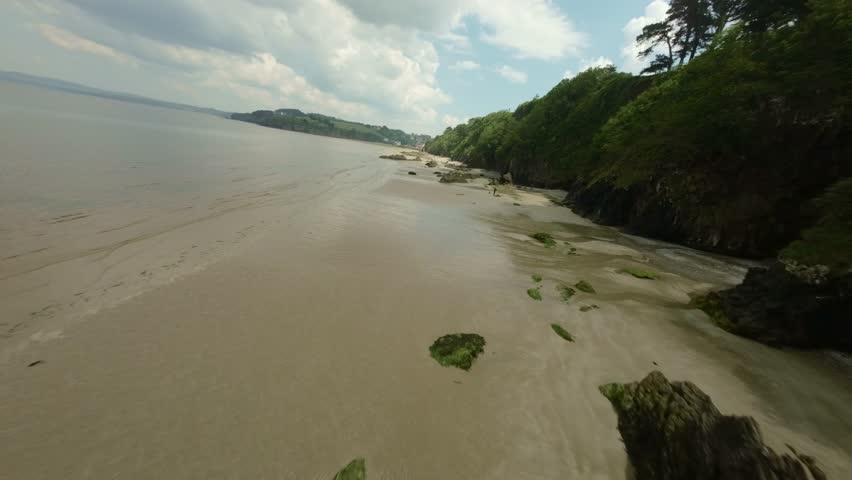 Flyover Rocks On The Shore Of Plage du Ris In Douarnenez, Brittany, France. FPV Shot