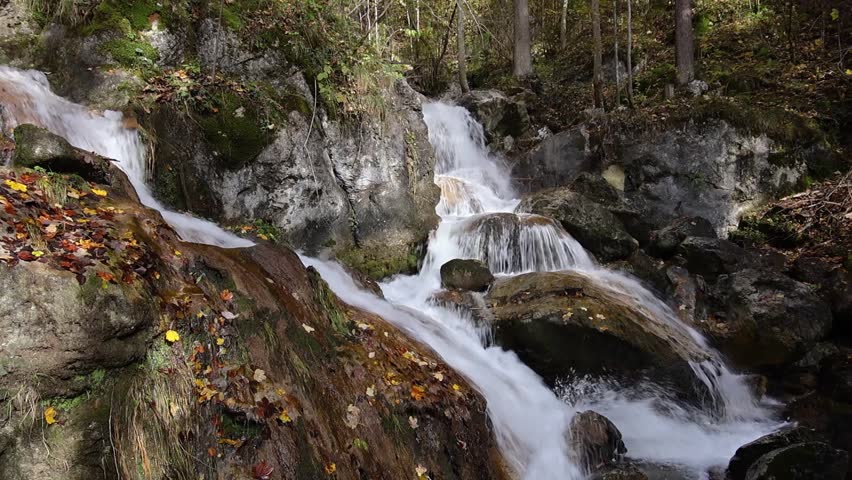 Autumn waterfall on the river Myra in Lower Austria, discover the beauty of a flowing river and cascading waterfall in autumn colors in October in the Myra falls valley in the forest a rocky river bed