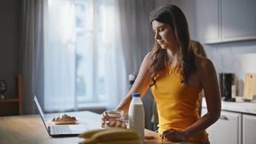 Wife husband cooking breakfast at kitchen closeup. Smiling woman pouring cereal granola in bowl preparing food via online recipe at laptop. Lovers looking computer screen watching video culinary  - Powered by Shutterstock - Get 15% off with code: PIKWIZARD15