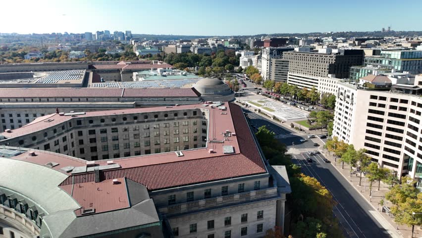 Aerial view of Washington DC showcasing White House, EPA, buildings, a large plaza, trees, and streets with cars. The image captures a blend of urban and natural elements.