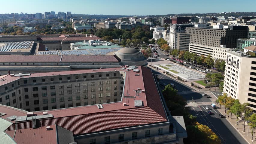 Aerial view of Washington DC showcasing White House, EPA, buildings, a large plaza, trees, and streets with cars. The image captures a blend of urban and natural elements.