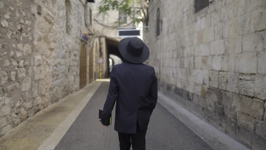 View Behind Male Orthodox Jew Roaming In Old City Of Jerusalem In Israel. medium shot, slow motion