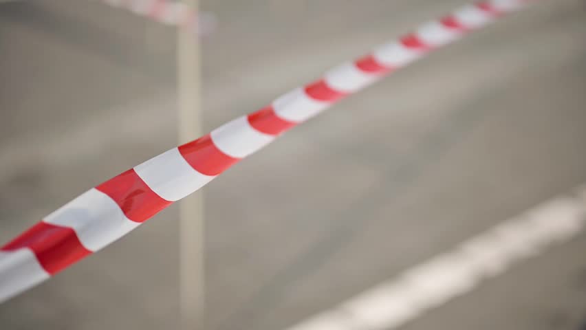 Close-up of caution tape stretched across an area, with bold colors