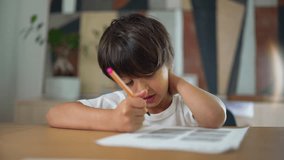 Young boy working on a drawing with focus and concentration, sitting at a table in a home environment, showcasing creativity, learning, and childhood development - Powered by Shutterstock - Get 15% off with code: PIKWIZARD15