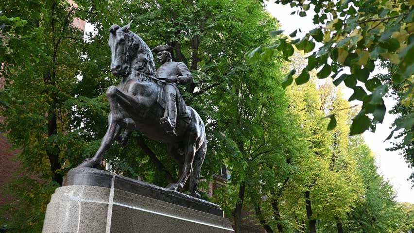 Boston, MA, USA - October 10, 2024: the iconic architecture of Boston with the famous landmark the Paul Revere Riding a Horse sculpture at Hanover street in front of the North Church on a sunny day.