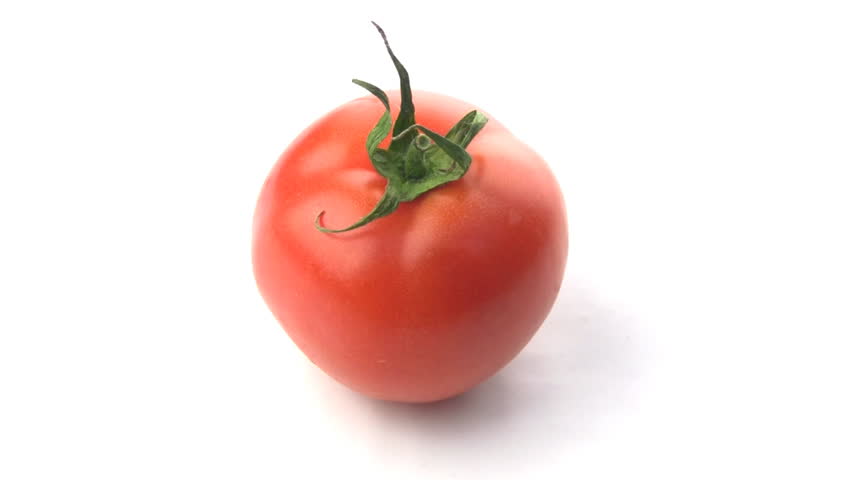 Juicy fresh tomato isolated spins around its axis