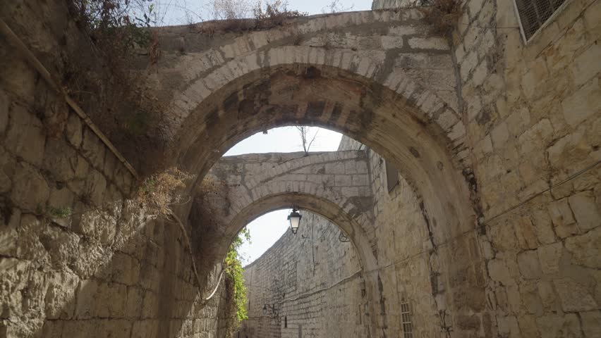Walking Through Narrow Alley With Arch Passage Between High Stone And Brick Walls In Jerusalem - POV