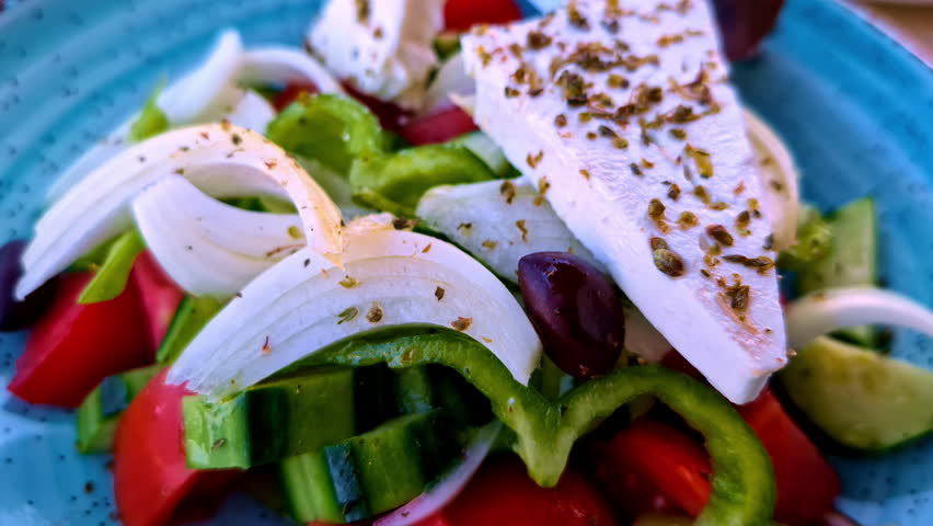 Salad plate with raw vegetables and feta cheese. Zoom out close up