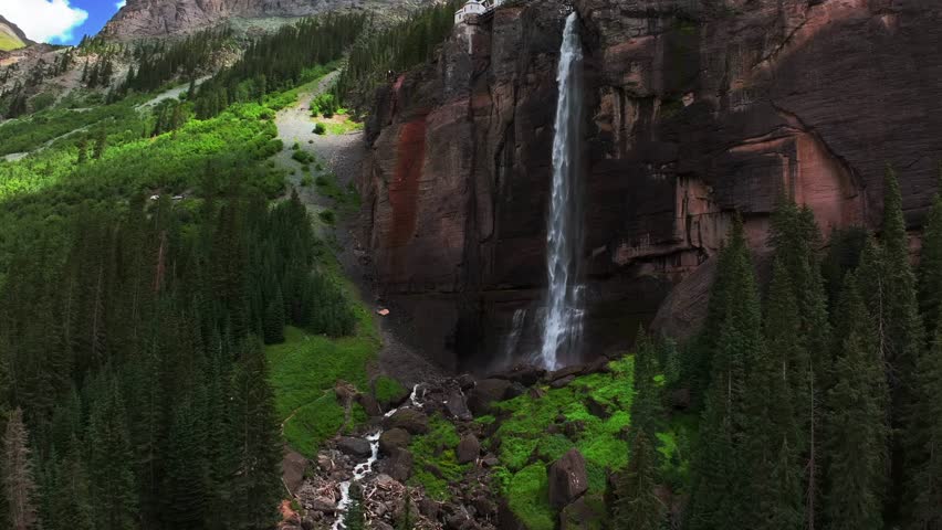 Summer Telluride Bridal Veil Falls Waterfall Colorado powerplant house aerial drone Box Canyon Black Bear Pass Road Rocky Mountains 4wd hiking blue sky cliffside Uncompahgre Forest back pan up