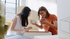 Two young Asian woman happy and smiling unpack boxes at new house, relocation and people in real estate or apartment. Moving house concept - Powered by Shutterstock - Get 15% off with code: PIKWIZARD15