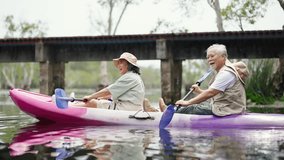 Happy Asian family senior couple kayaking in the river on summer holiday vacation. Healthy elderly people enjoy and fun outdoor active lifestyle travel nature, sport and rowing a boat in the lake. - Powered by Shutterstock - Get 15% off with code: PIKWIZARD15