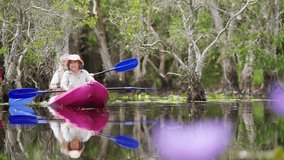 Happy Asian family senior couple kayaking in the river on summer holiday vacation. Healthy elderly people enjoy and fun outdoor active lifestyle travel nature, sport and rowing a boat in the lake. - Powered by Shutterstock - Get 15% off with code: PIKWIZARD15