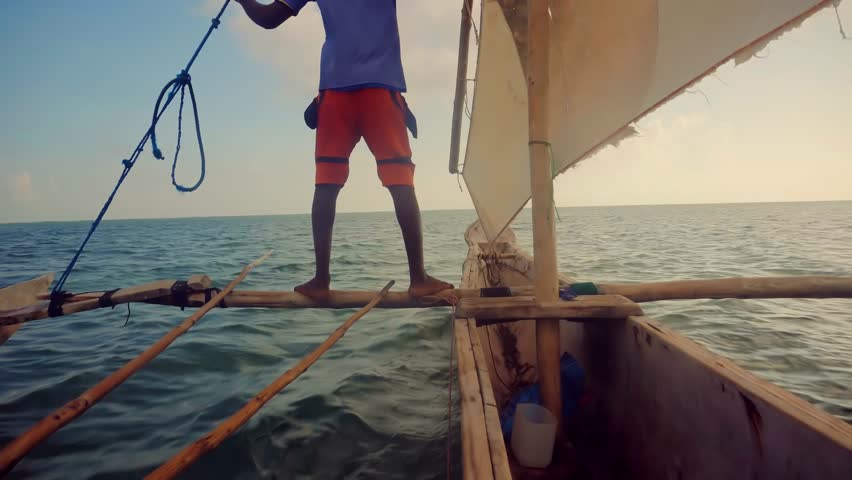 Traditional Wooden Boat Zanzibar Fishermen In Indian Ocean.Tourist Exploring Tropical Beach.Vacation Adventure In Boat On Indian Ocean.Fisherman On Zanzibar Tanzania.Water Tourism Holidays Vacation.