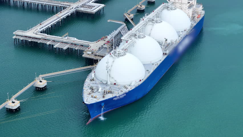 LNG (Liquified Natural Gas) tanker anchored in Gas terminal gas tanks for storage. Oil Crude Gas Tanker Ship. LPG at Tanker Bay Petroleum Chemical or Methane freighter export import transportation