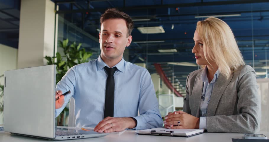 Colleagues working together on business accounting with a laptop in the office during meeting. Their teamwork and discussion ensure efficient collaboration and smooth business operations.