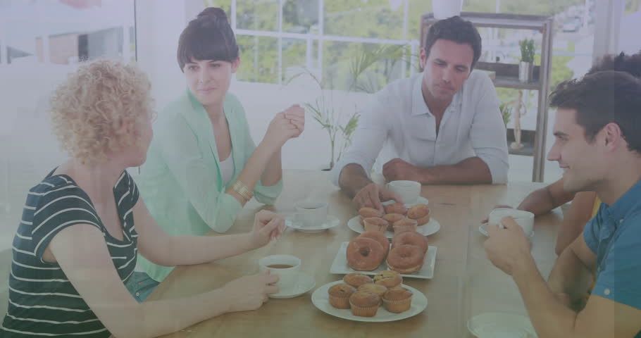 Animation of numbers and letters changing over diverse friends having cupcakes and donuts at home. Digital composite, text, alphabet, digit, togetherness, sweet food, enjoyment and lifestyle.