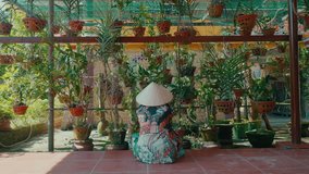 Asian person in conical hat working in the garden. Back view. Distant view. - Powered by Shutterstock - Get 15% off with code: PIKWIZARD15