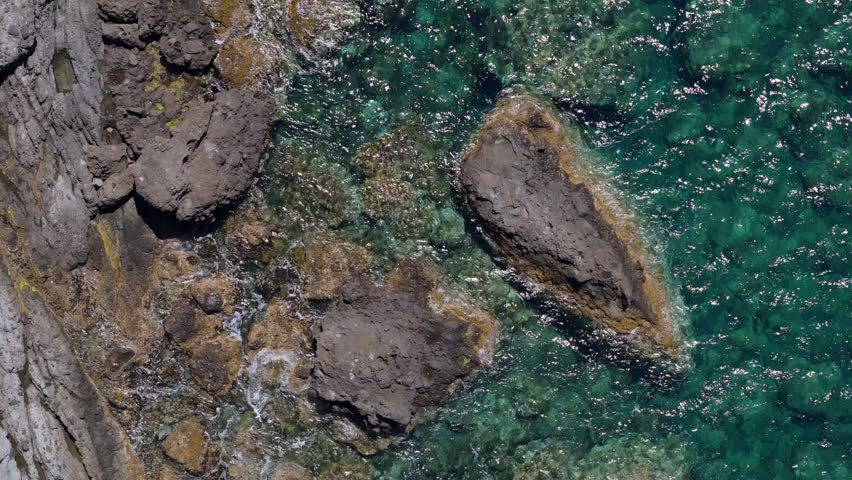 Closeup of a rock formation on the Sardinian coast. drone zoom in.