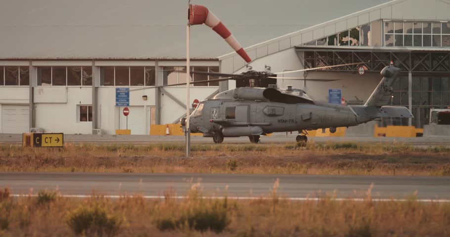 Military Helicopter with Spinning Rotors Moving on Airport Tarmac for Passenger Transport and Air Operations. High quality 4k footage