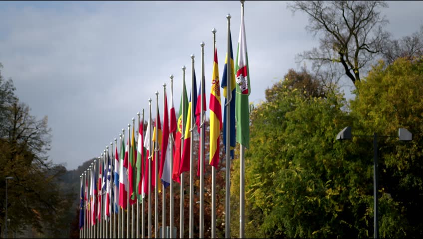Line of flags of Europe Union members in a line in fron of Slovenian Parlament