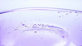 Close-up of abstract purple liquid splash with bubbles and fluid motion on light background. - Powered by Shutterstock - Get 15% off with code: PIKWIZARD15