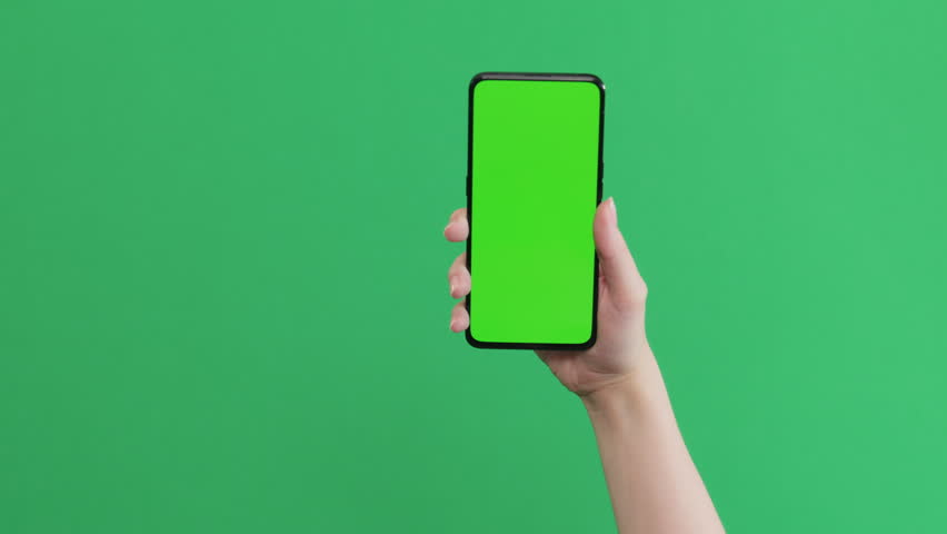 Young female hand show smartphone with green screen on green background