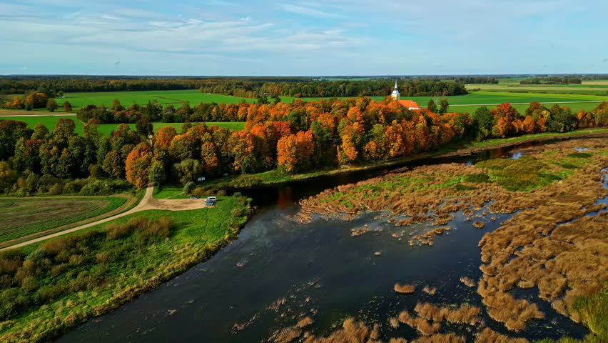 Aerial perspective of Lielupe River and cultural center surrounding Mežotne Church in Latvia. autumn landscape