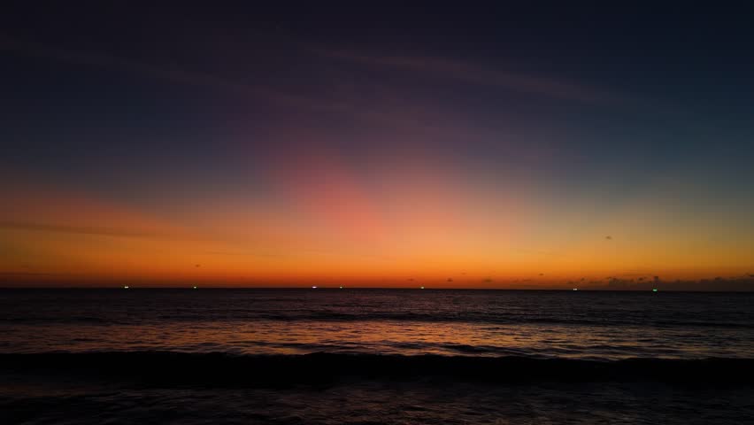 Aerial view of sunset Cinematic drone aerial view beautiful evening sunset in sky over sea.Beautiful ocean during sunset in summer. Ocean with an sun on the horizon while orange color sunset. Beautifu