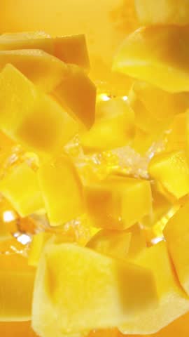 Super Slow Motion of Falling Mango Pieces into Juice. Filmed on High Speed Cinema Camera, 1000fps.