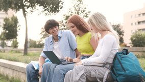 Cheerful friends using netbook in college campus - Powered by Shutterstock - Get 15% off with code: PIKWIZARD15