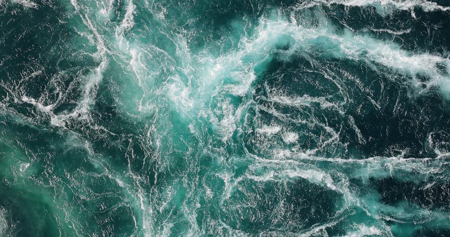 Blue waves of water of the river and the sea meet each other during high tide and low tide.