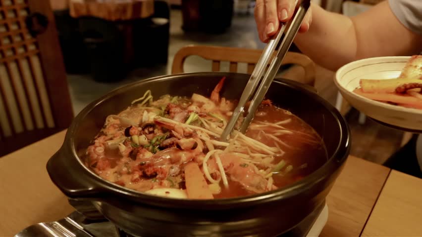 Fish and seafood hotpot cooking close up view in the traditional restaurant in Seoul Korea