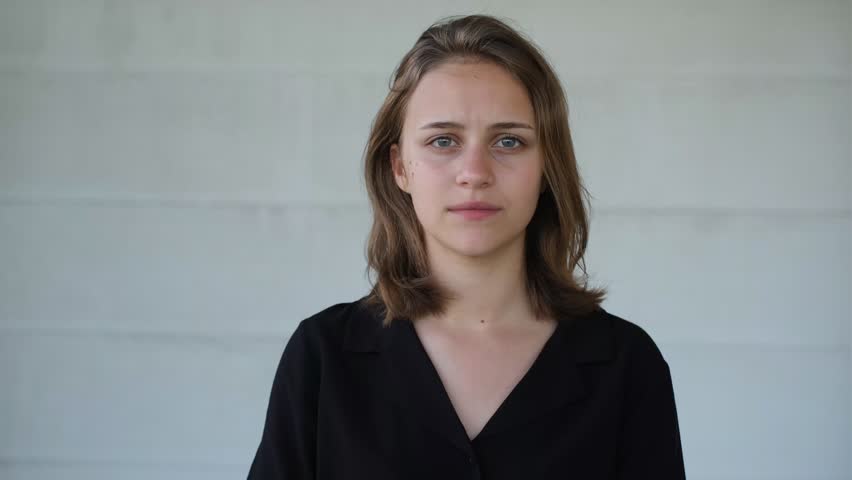 portrait of a young beautiful upset woman barely holding back tears