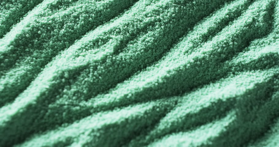 Close-up of a textured green fabric with a wavy pattern. The image showcases the intricate details and texture of the material, emphasizing its potential use in various fabrics.