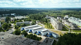 The industrial facility is in a lush green landscape, emphasizing environmental integration and sustainability - Powered by Shutterstock - Get 15% off with code: PIKWIZARD15