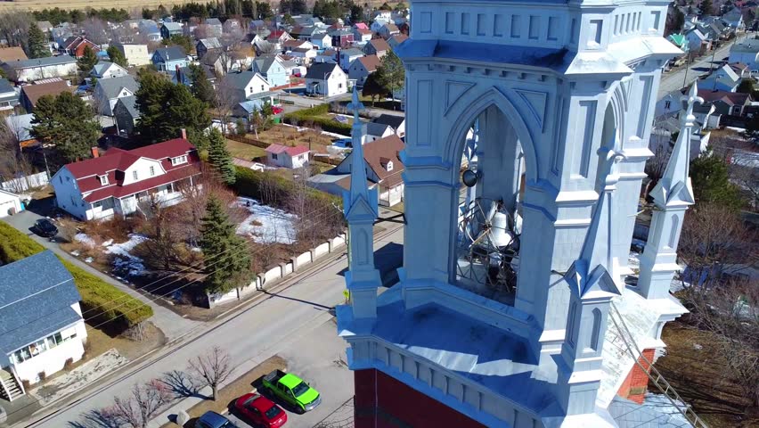 A drone films while moving away from a magnificent church steeple in a small country town. Church of Saint-Rémi, Price, Gaspe Peninsula, Quebec,Canada, 2024.
