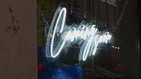 At night, a neon sign in a shop window reflects urban lights, enhancing the energetic and modern atmosphere of the downtown area - Powered by Shutterstock - Get 15% off with code: PIKWIZARD15