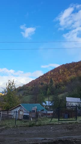 Mountain landscape with blue sky, trees in the foreground